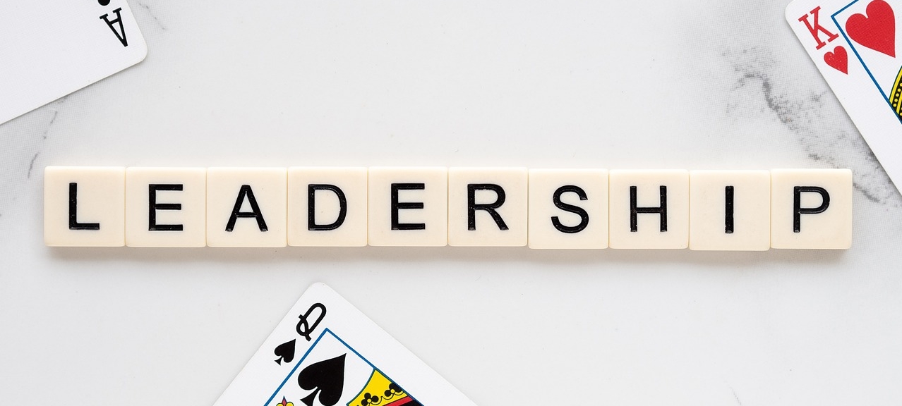 White dominos set up in linear fashion depicting the word "Leadership"