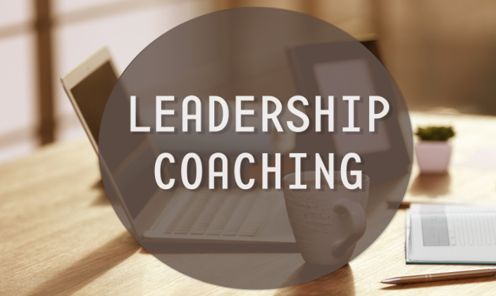 Graphic of computers on a table and the words Leadership Coaching