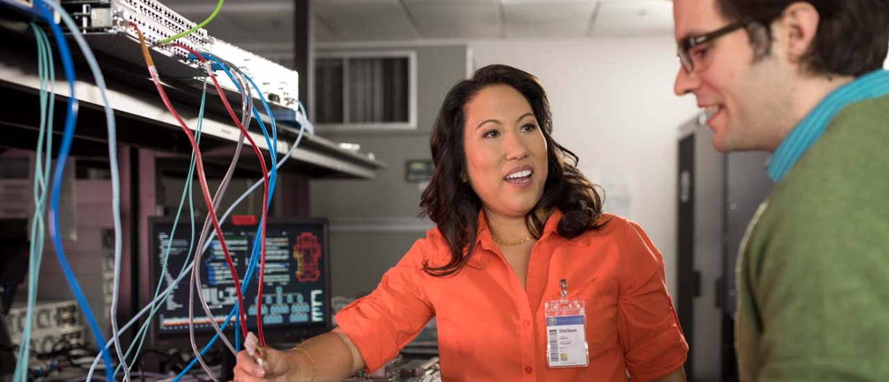 Woman speaking to colleague at her workplace working in manufacturing area