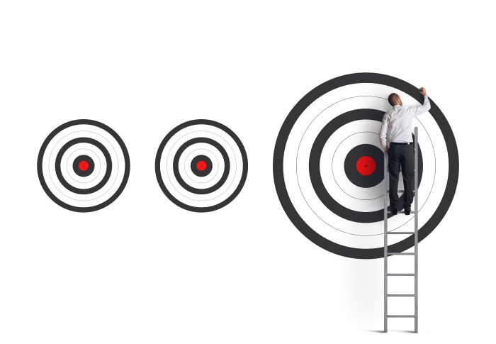 image of a person on a ladder painting the larger of three targets