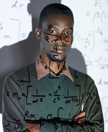 Man with math formulas projecting on him from overhead projector