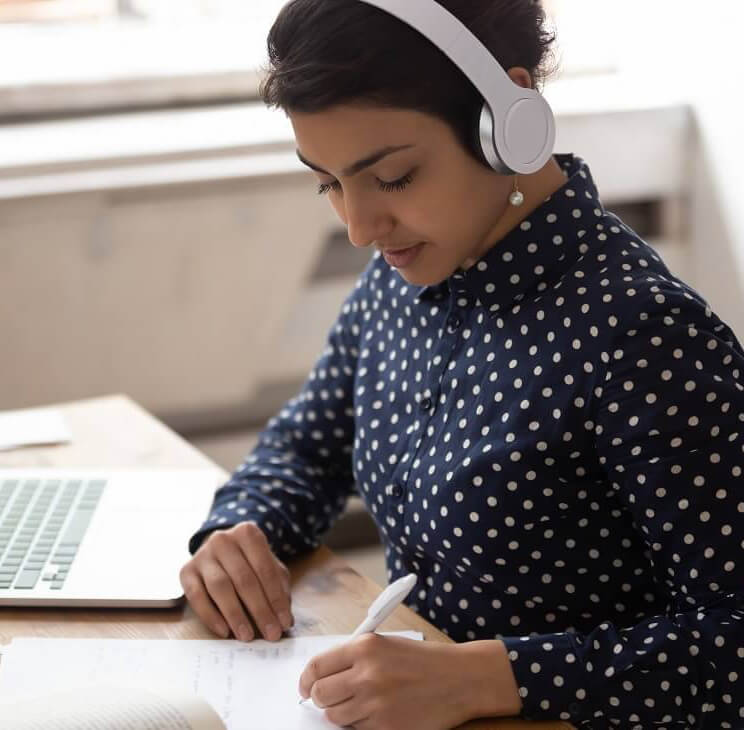 Woman writing with left hand with pen and paper