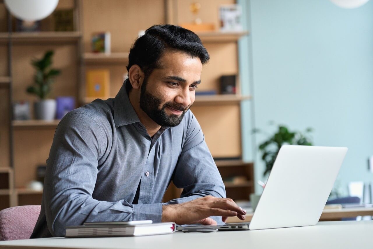 A University of Phoenix student talking to a personal money coach over their laptop