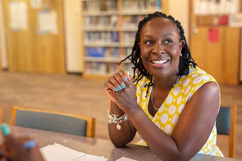 Smiling student in a library