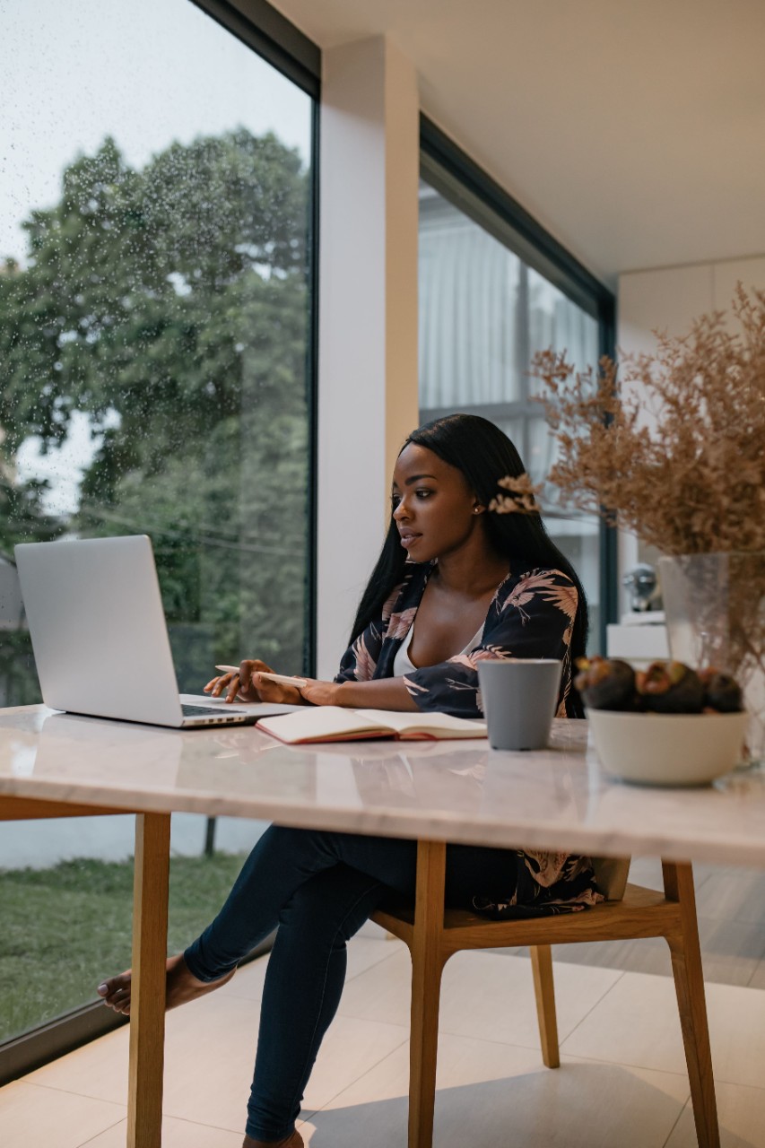 Student sitting at desk doing schoolwork on laptop