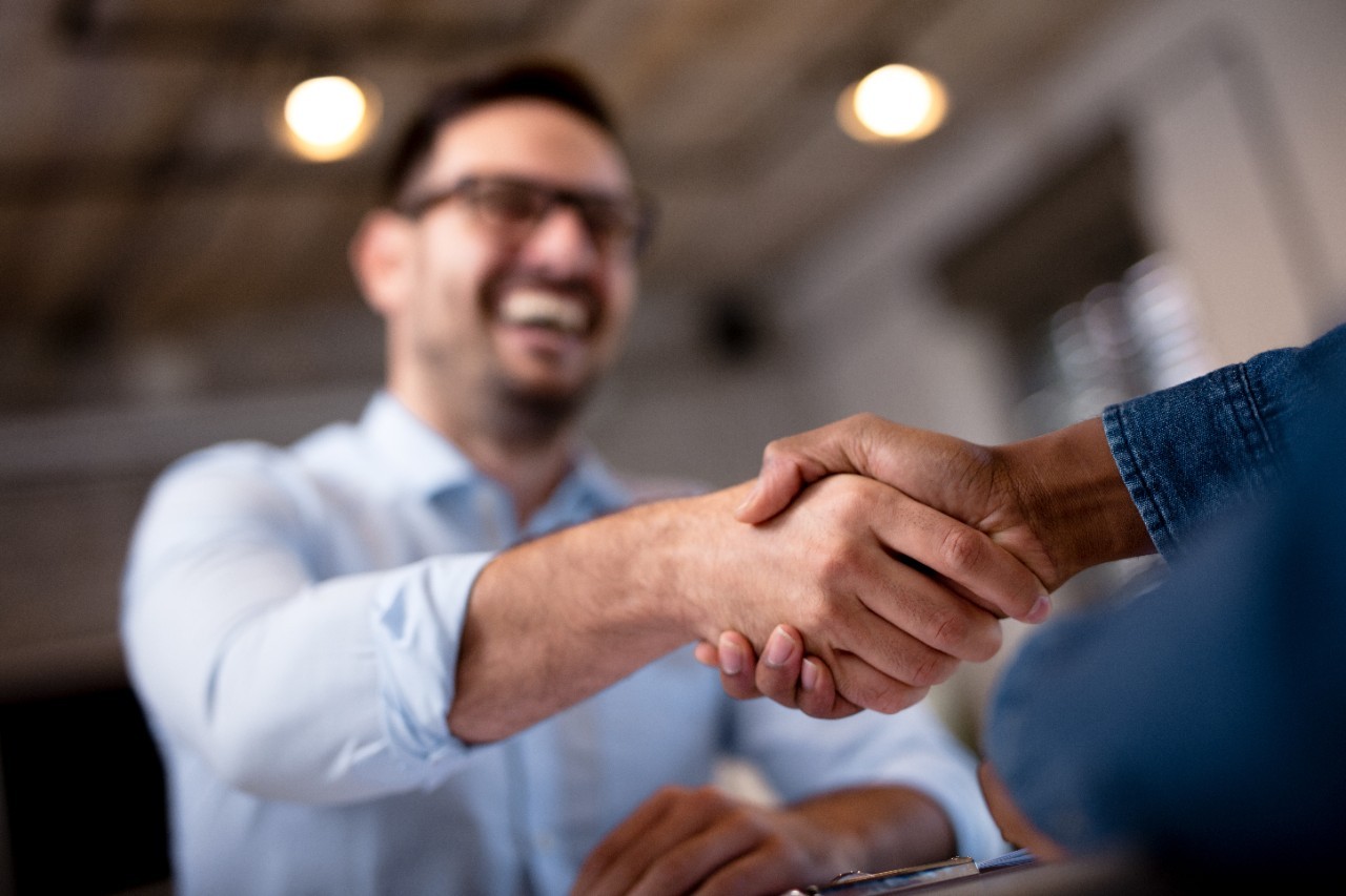 Student shakes hands with a team representative