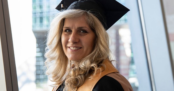 Smiling student in graduation cap and gown