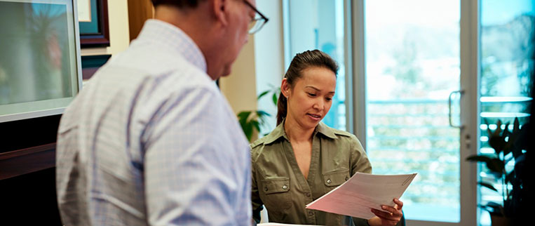 woman reading report in office