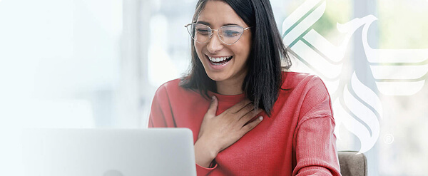 picture of a person smiling while looking at their laptop