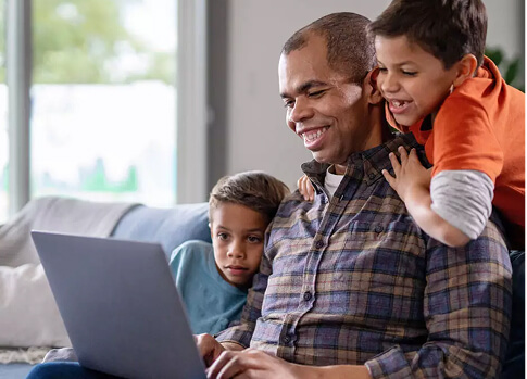 Stephen P. smiles as he shares an encouraging message from his Academic Advisor with his 2 sons