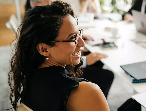 Smiling personnel manager celebrates a successful campaign with her team
