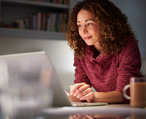 woman works at her computer with AI.