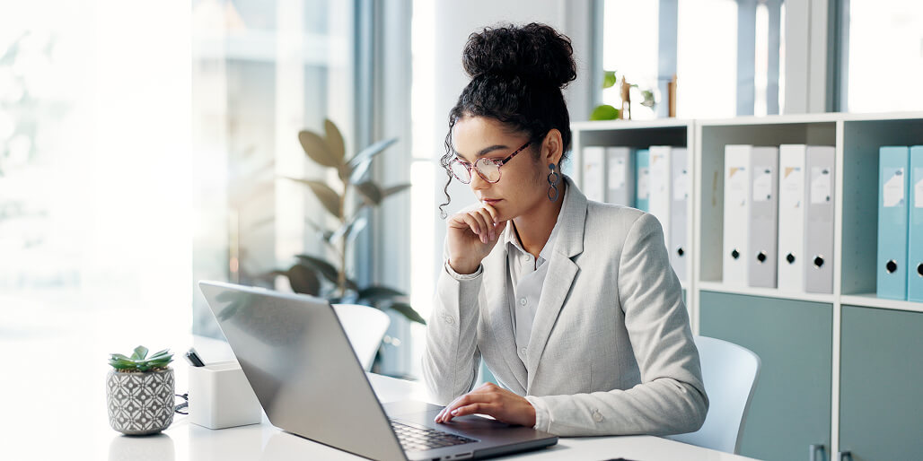 Woman reviews options employee candidates on her laptop.