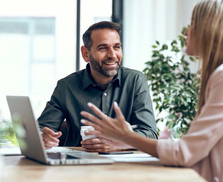 A man and woman discuss skills opportunities at their office.