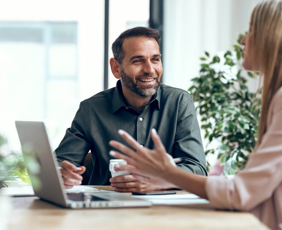 A man and woman discuss skills opportunities at their office.