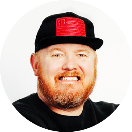 Will Irey smiling wearing baseball cap and black t-shirt