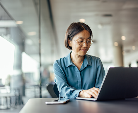 Woman signing up for tuition assistance on her laptop